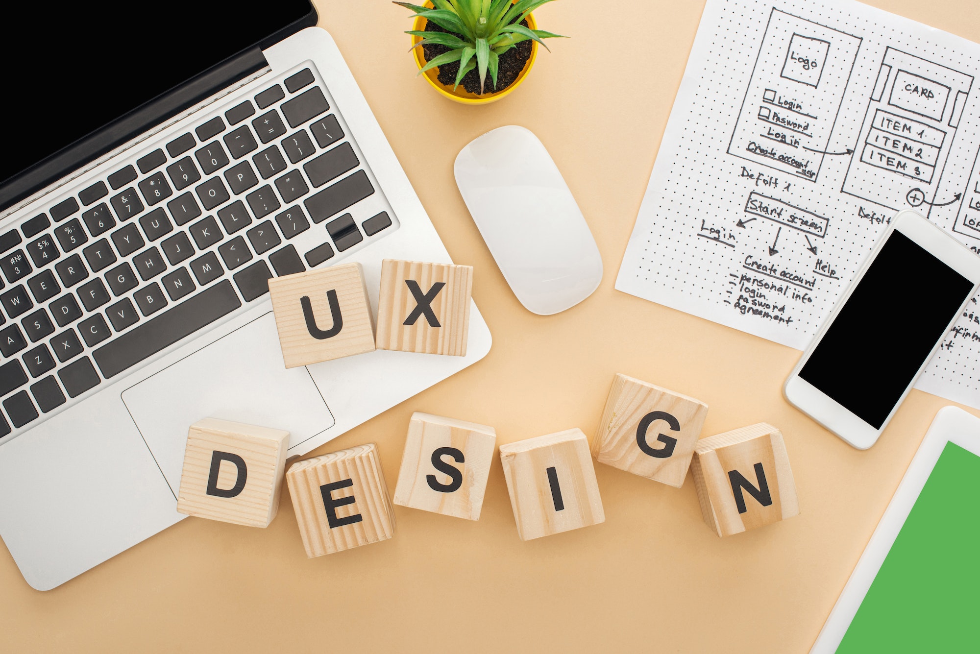 top-view-of-gadgets-near-wooden-blocks-with-ux-design-lettering-website-design-template-and-green.jpg